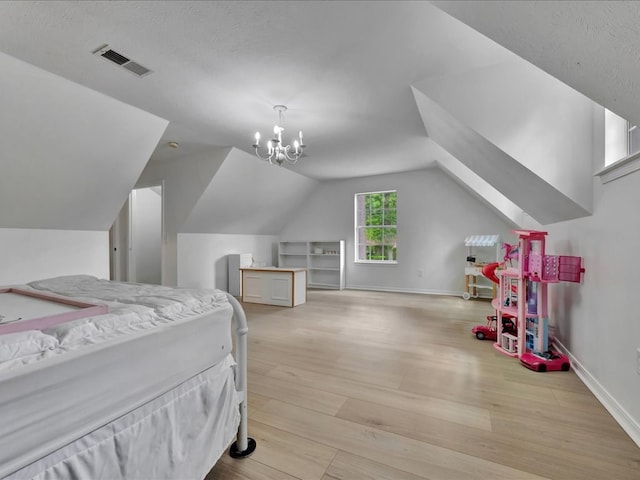 107 Bending Oak Dr, Lufkin, TX 75904 - bedroom with light wood-type flooring, lofted ceiling, and a chandelier