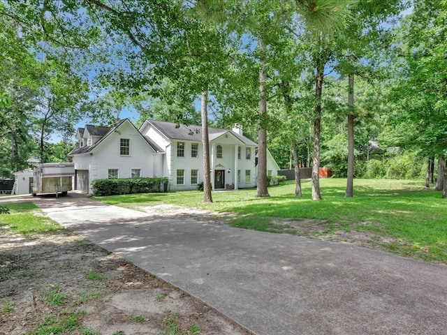 107 Bending Oak Dr, Lufkin, TX 75904 - neoclassical home with concrete driveway, a front lawn, and a chimney