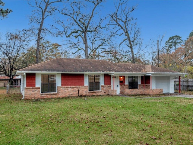 single story home featuring a front lawn and a garage