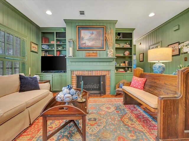 2211 Copeland St, Lufkin, TX 75904 - living room with visible vents, wooden walls, built in features, and a fireplace