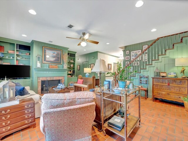 2211 Copeland St, Lufkin, TX 75904 - living area featuring visible vents, a fireplace, recessed lighting, a ceiling fan, and brick floor