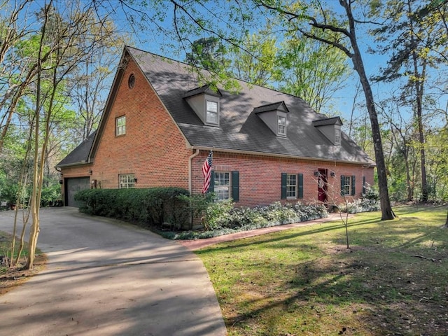 2211 Copeland St, Lufkin, TX 75904 - view of side of home featuring driveway, brick siding, a garage, and a yard