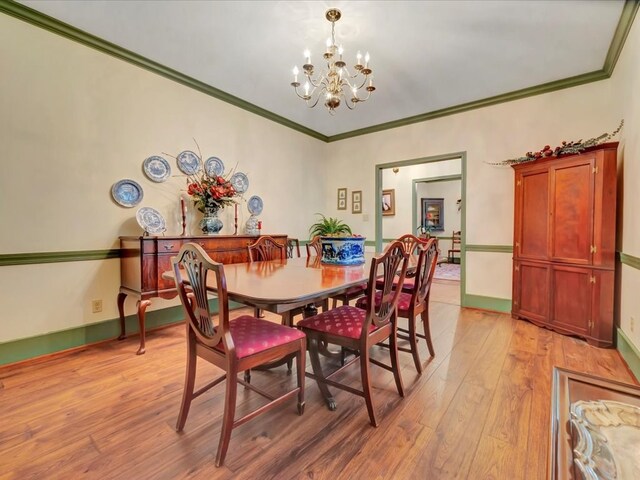 2211 Copeland St, Lufkin, TX 75904 - dining room featuring baseboards, a notable chandelier, crown molding, and light wood-type flooring