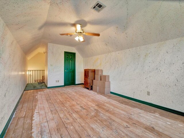 2211 Copeland St, Lufkin, TX 75904 - additional living space with a textured ceiling, visible vents, hardwood / wood-style flooring, ceiling fan, and lofted ceiling