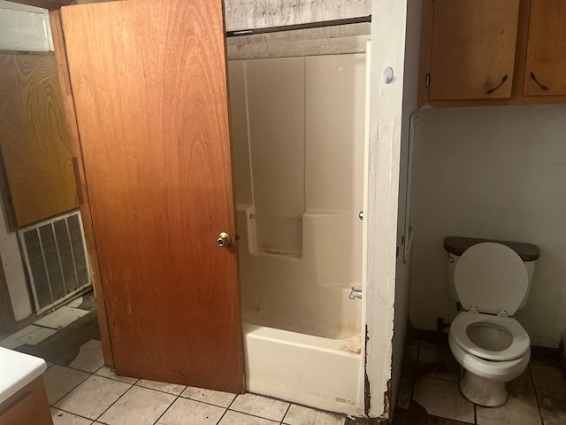 bathroom featuring tile patterned floors, toilet, and shower / tub combination