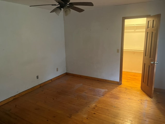 empty room with ceiling fan and light wood-type flooring