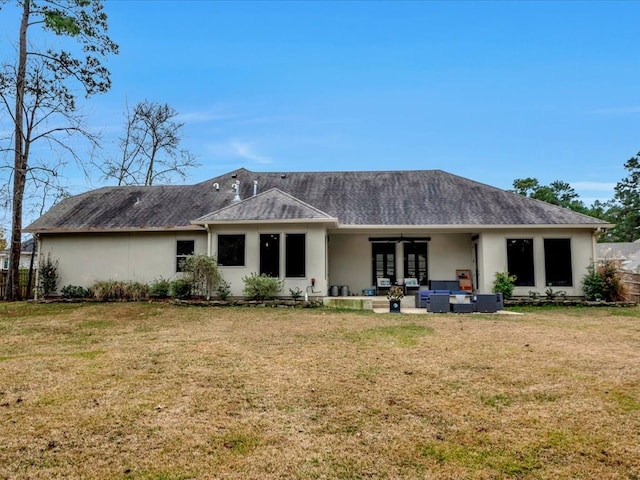 rear view of house featuring outdoor lounge area, a lawn, and a patio