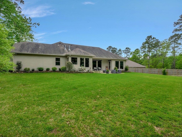 210 Mission Hills Dr, Lufkin, TX 75901 - rear view of property featuring stucco siding, fence, a patio, and a lawn