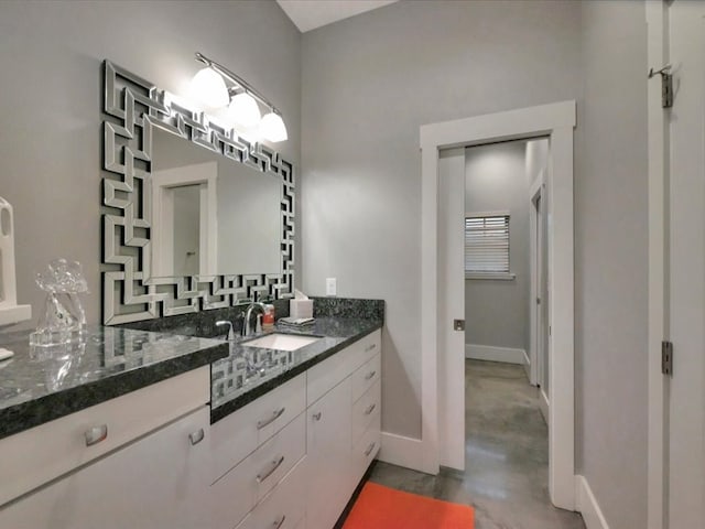 210 Mission Hills Dr, Lufkin, TX 75901 - bathroom featuring baseboards, vanity, and finished concrete flooring