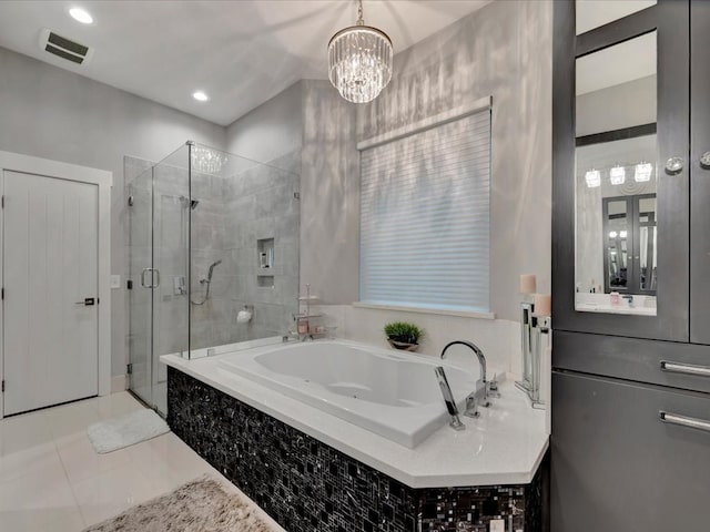210 Mission Hills Dr, Lufkin, TX 75901 - bathroom with tile patterned floors, an inviting chandelier, visible vents, a bath, and a stall shower