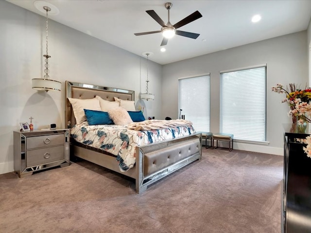 bedroom featuring ceiling fan and dark carpet