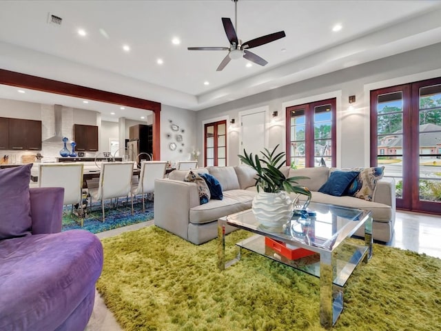 living room with ceiling fan and french doors