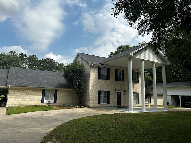 neoclassical / greek revival house featuring cooling unit and a front yard