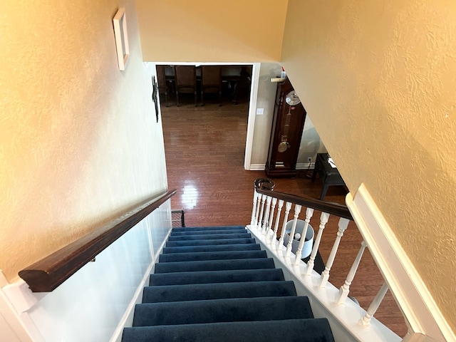 staircase with hardwood / wood-style flooring