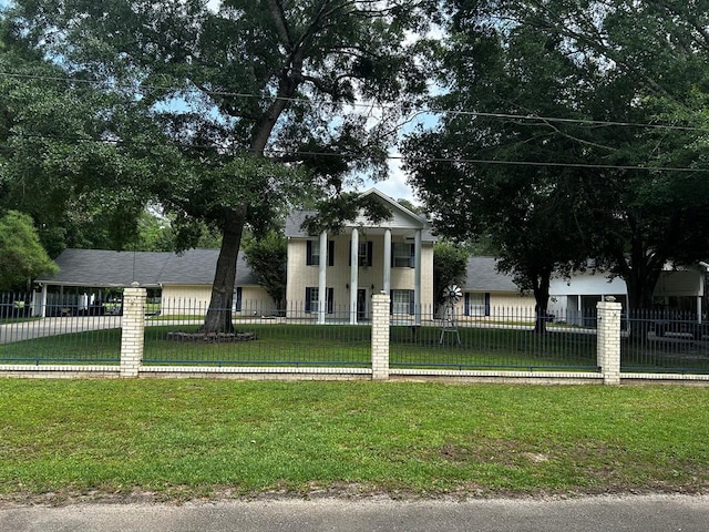 greek revival inspired property with a front lawn