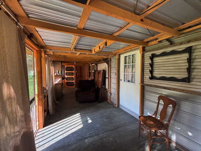 unfurnished sunroom featuring beam ceiling