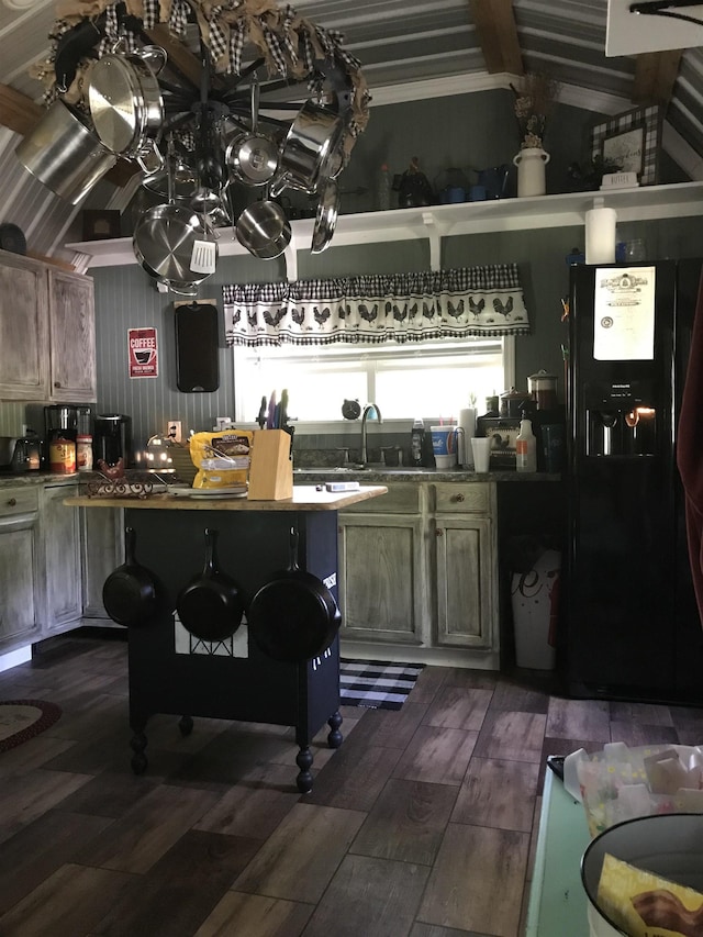 kitchen featuring sink, black fridge with ice dispenser, and dark wood-type flooring