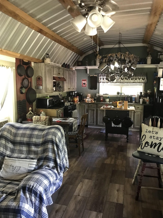 dining room featuring lofted ceiling with beams, dark wood-type flooring, and ceiling fan with notable chandelier