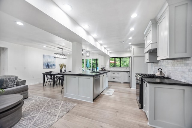 kitchen with open floor plan, tasteful backsplash, dark countertops, and stainless steel appliances