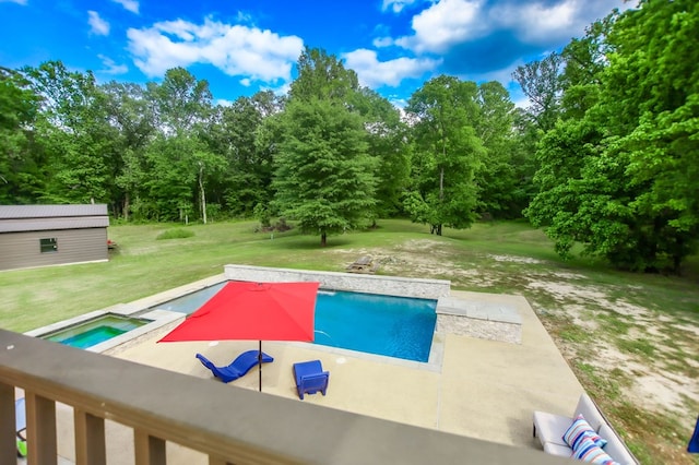 pool with a lawn, an in ground hot tub, an outdoor structure, and a patio area