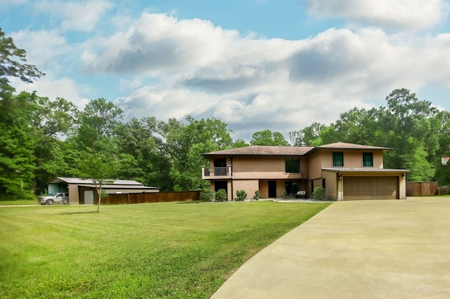 prairie-style home featuring fence, a garage, stucco siding, a front yard, and concrete driveway
