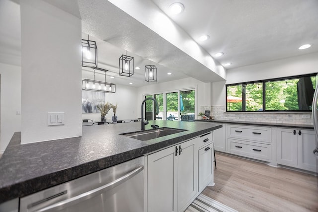 kitchen featuring recessed lighting, a sink, and dishwasher
