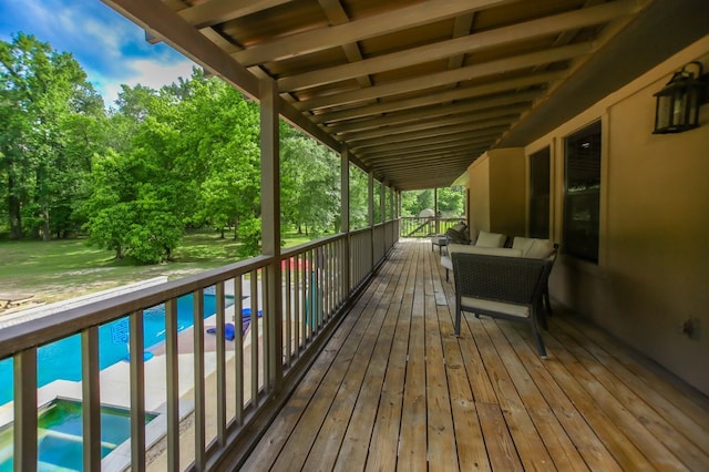 wooden terrace featuring a lawn and an outdoor pool