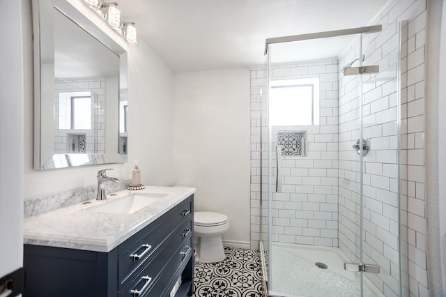 bathroom featuring vanity, tile patterned flooring, a stall shower, and toilet