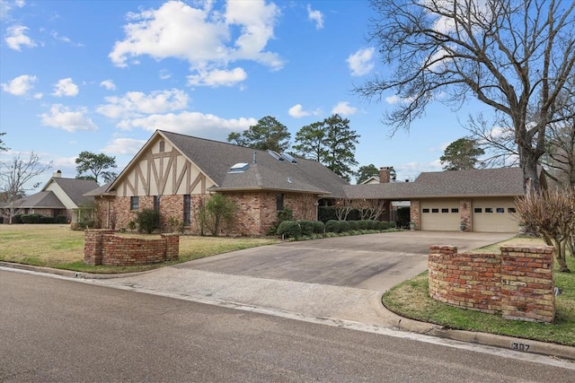 view of front of home featuring a front yard and a garage