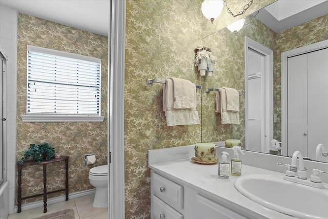 bathroom featuring tile patterned flooring, vanity, and toilet