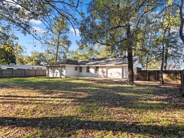 rear view of house with a yard