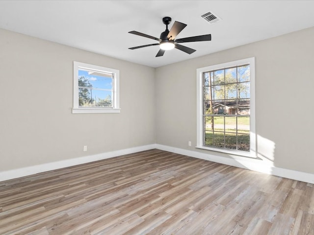 unfurnished room with light hardwood / wood-style floors, plenty of natural light, and ceiling fan