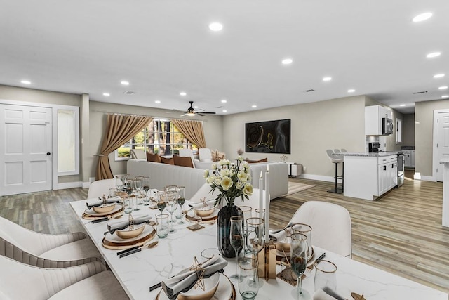 dining space with light wood-type flooring and ceiling fan