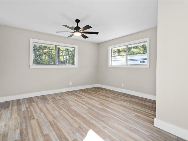 spare room featuring light hardwood / wood-style flooring and ceiling fan