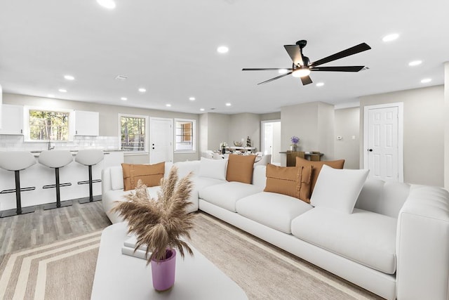 carpeted living room featuring ceiling fan