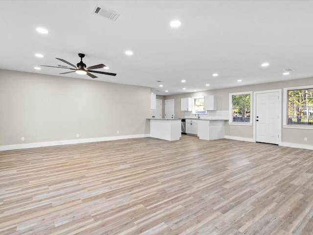 unfurnished living room with ceiling fan and light hardwood / wood-style flooring