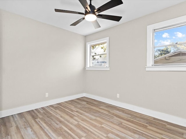 empty room with ceiling fan and light hardwood / wood-style floors