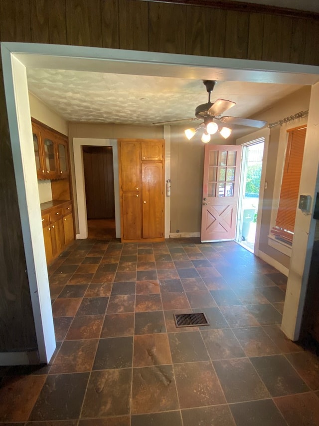 interior space featuring a textured ceiling and ceiling fan