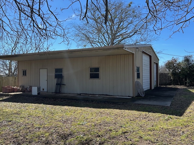 view of outbuilding with an outdoor structure and fence