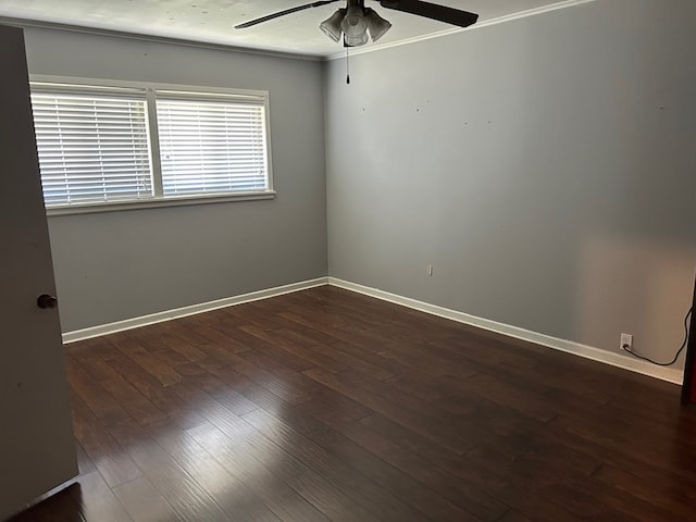 empty room featuring a ceiling fan, baseboards, and dark wood-style flooring