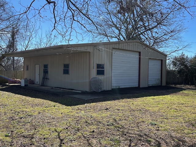 garage featuring a garage and fence