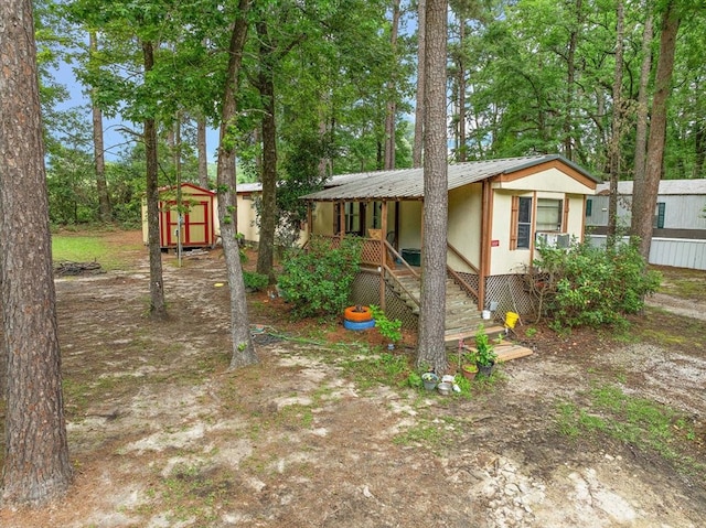 view of front facade featuring a storage shed