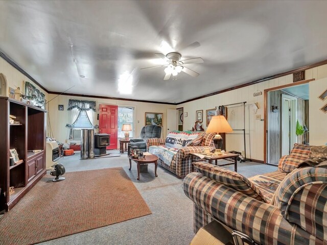 309 County Barn Rd, Lufkin, TX 75904 - carpeted living room with a wood stove, crown molding, and ceiling fan