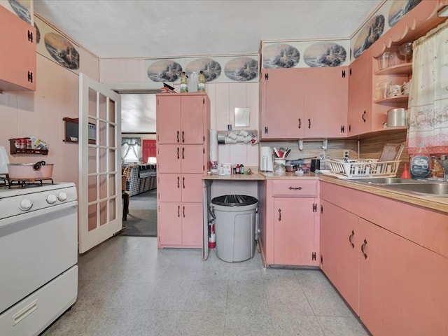 309 County Barn Rd, Lufkin, TX 75904 - kitchen with white gas range oven, open shelves, light countertops, and french doors