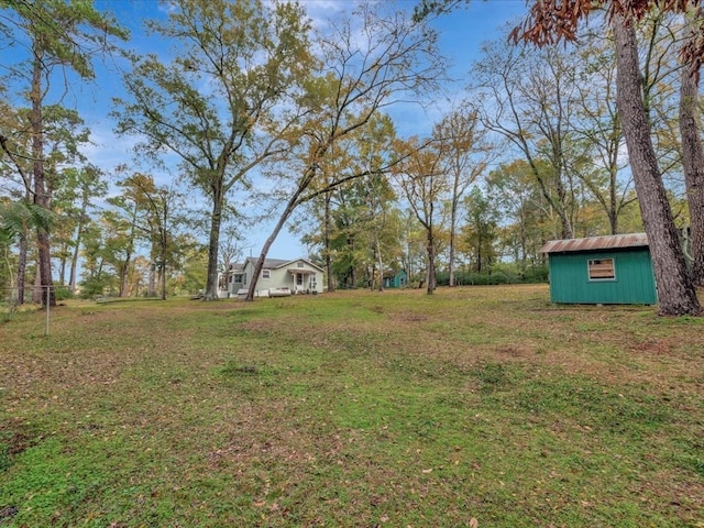 309 County Barn Rd, Lufkin, TX 75904 - view of grassy yard featuring an outdoor structure and a storage unit