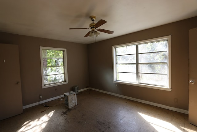 empty room with plenty of natural light and ceiling fan