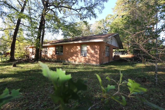 view of home's exterior with a yard