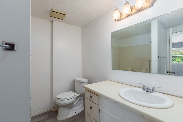 full bathroom with walk in shower, toilet, a textured ceiling, vanity, and wood finished floors