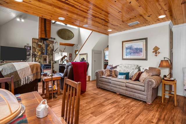 183 Holly Cir, Etoile, TX 75944 - living room featuring light wood-style flooring, a wood stove, crown molding, wooden ceiling, and lofted ceiling