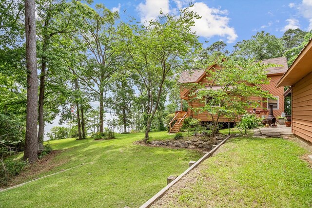 183 Holly Cir, Etoile, TX 75944 - view of green lawn with a deck and stairway